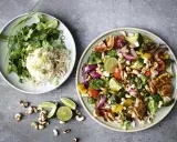 Två tallrikar med nyttig fredagsmat: ris med koriander och grönsaker med kyckling, cashewnötter och lime.