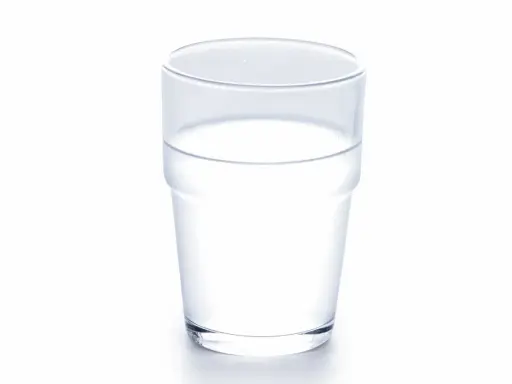 Ett glas med klart vatten, som symboliserar att kokosvatten nyttigt är ett bra val för återfuktning.