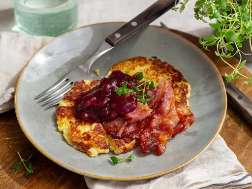 Stekta potatisbullar av potatismos, toppade med lingonsylt och knaperstekt bacon. En klassisk svensk rätt som väcker aptiten.